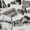 Scattered black and white postcards featuring historic european landmarks.