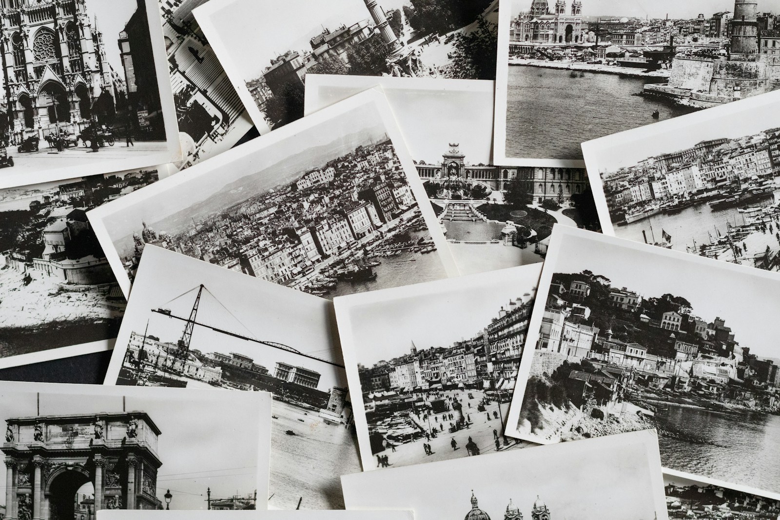 Scattered black and white postcards featuring historic european landmarks.