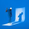 A man poses, casting a shadow.
