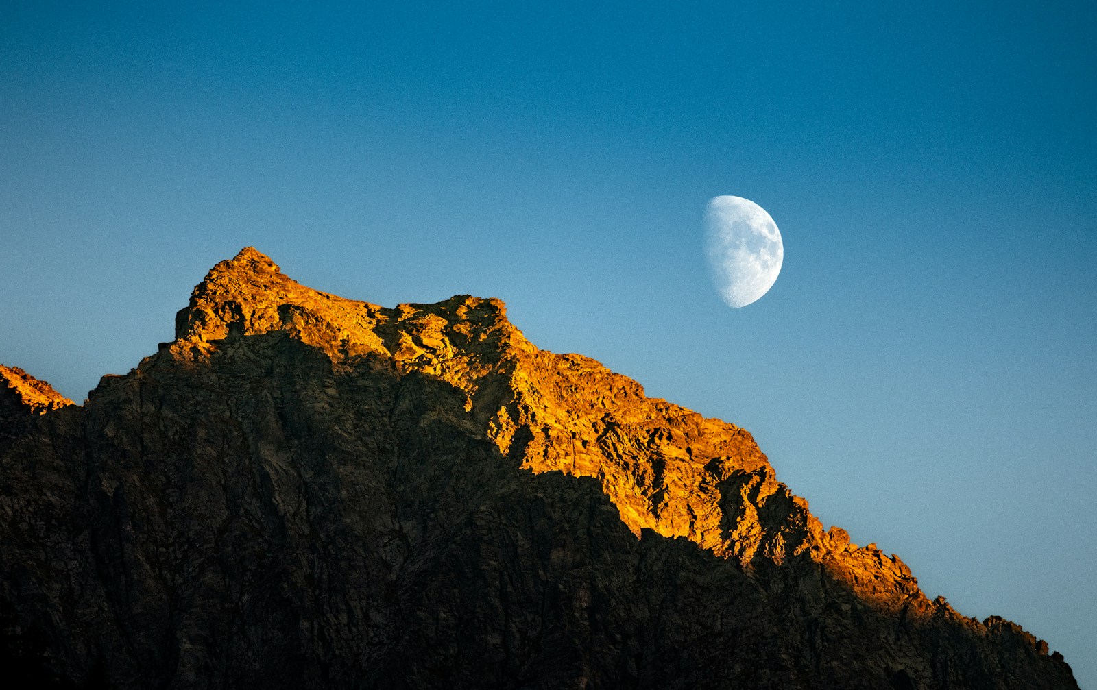Mountain peak illuminated by the moon.