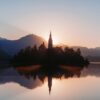 Sunset illuminates a church on an island.
