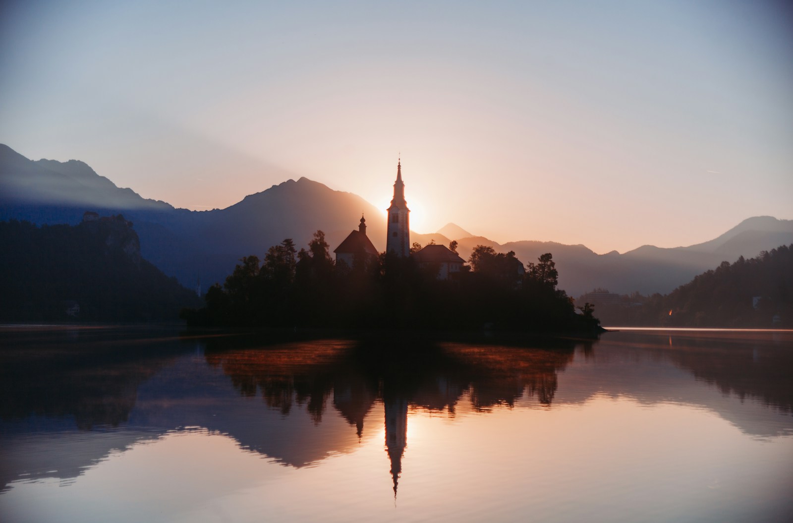 Sunset illuminates a church on an island.