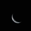 Crescent earth visible in the dark expanse of space