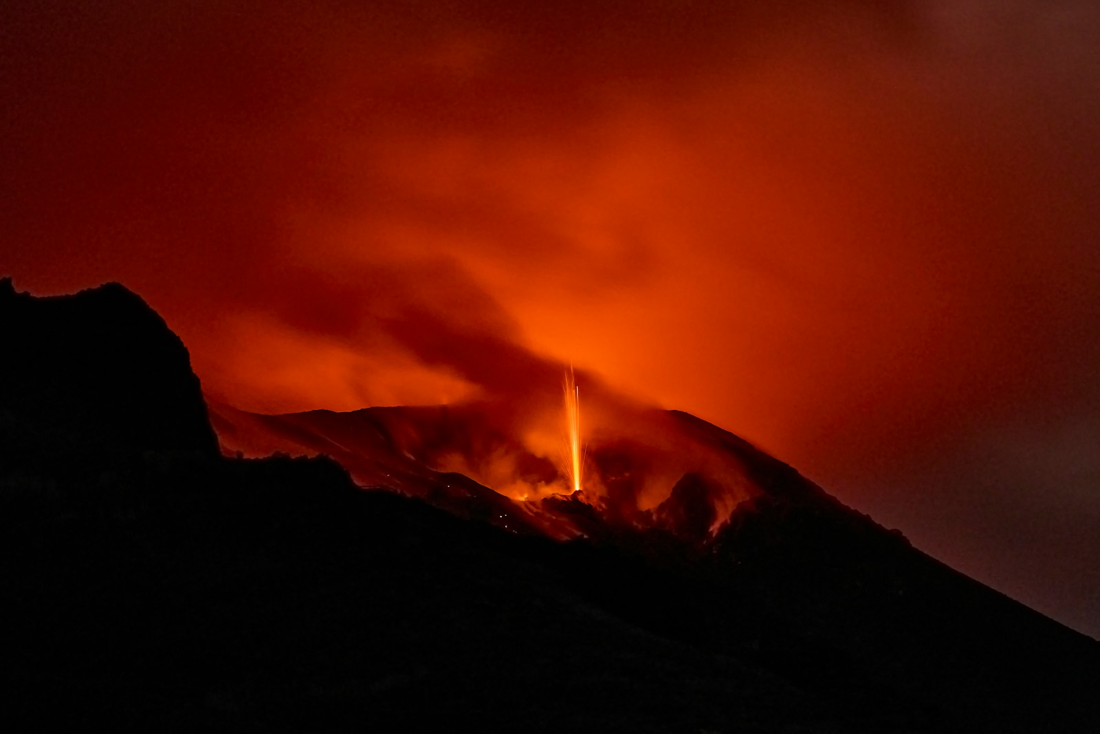 Volcano erupting with glowing lava and smoke