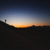 a person standing on top of a mountain at sunset