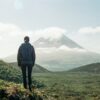 A person admiring a mountain vista.