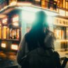 Woman walking on a wet street at night